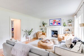 A living room with a fireplace, sofas, and a coffee table.
