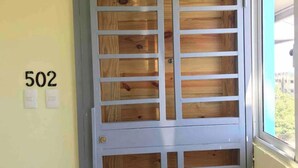 A door with a grid pattern and a number '502' on the wall beside it. - MODERN APARTMENT IN FRONT OF THE SEA. (E17AM502) (Santo Domingo)