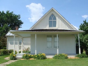 A white church with a gabled roof and a central arched window.