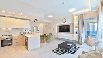 Deluxe Apartment, 1 Bedroom | Living area | 32-inch Smart TV with cable channels, TV