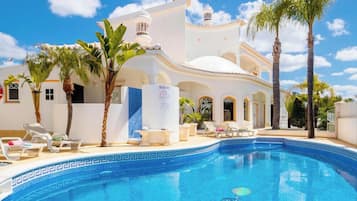 A heated pool, sun loungers