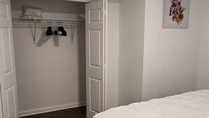 A bedroom with a bed, a closet, and a ceiling light. - Entire Lovely Apt* 5 Miles to EWR* Free Parking (Linden)