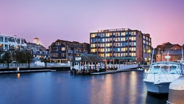 A waterfront hotel with multiple stories, a dock, and boats. - A PLUS room at Wyndham Inn on the Harbor, perfect location (Newport)