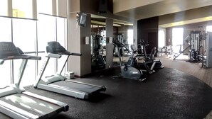 A gym with treadmills, elliptical machines, and weight equipment.