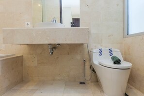 A bathroom with a sink, mirror, and toilet. - Posh 2BR at The Empyreal Condominium Epicentrum Apartment (Jakarta)