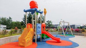 A playground with slides and climbing structures. - Cozy Studio at Amazana Serpong Apartment (South Tangerang)