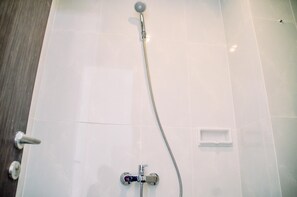 Room | Bathroom | Shower, free toiletries, towels - Chic and Cozy Studio at Serpong Garden Apartment (Cisauk)