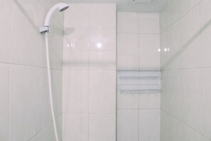A shower with a chrome head and a wall-mounted shelf. - Nice 2BR at Springlake Summarecon Bekasi Apartment (Bekasi)
