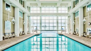 An indoor swimming pool with clear glass walls, sun loungers, and a no diving sign. - Majestic Sun A703*Gulf Views*Heated Pools/Hot Tubs*Beach Gear*Tennis (Destin)