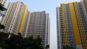 A high-rise residential building with multiple floors, balconies, and a yellow accent on one side. - Comfortable and Lovely 2BR Apartment at Springlake Summarecon (Bekasi)