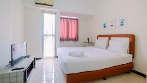 A hotel room with a bed, a TV, a small table, and a window with curtains. - Simple Furnished Studio Apartment at Maple Park (Jakarta)