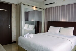Relax in a stylish room with a comfortable bed, large mirror, and modern design.