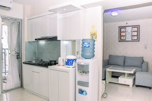 Fridge, stovetop, cookware/dishes/utensils - Comfortable Combined Unit 3BR at Bassura City Apartment near Mall (Jakarta)