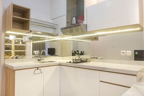Fridge, stovetop, cookware/dishes/utensils - Best Value 1BR Apartment Connected to Mall at Anderson Supermall Mansion (Surabaya)