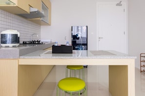 Fridge, stovetop, cookware/dishes/utensils - Homey 2BR Paddington Heights Apartment (Tangerang)