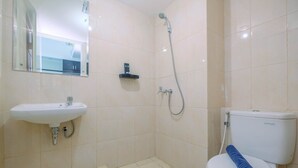 A bathroom with a sink, toilet, and shower.