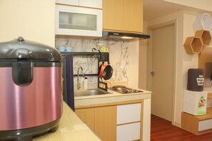 Fridge, stovetop, cookware/dishes/utensils - Comfort and Nice 2BR at Meikarta Apartment (Cikarang)