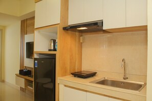 Fridge, stovetop, cookware/dishes/utensils - Cozy and Relax 2BR at Meikarta Apartment (Cikarang)