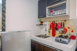 Fridge, stovetop, cookware/dishes/utensils - Homey and Compact 2BR Cibubur Village Apartment (Depok)