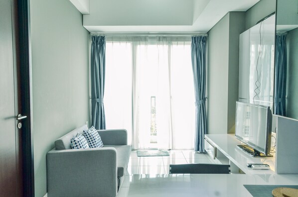 TV - Homey and Comfy 1BR at Casa de Parco Apartment (Pagedangan)