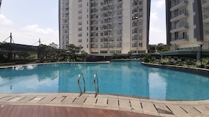 Outdoor pool - Homey and Comfy 1BR at Casa de Parco Apartment (Pagedangan)