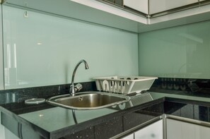 Fridge, stovetop, cookware/dishes/utensils - Cozy Living 1BR at Casa de Parco Apartment (Pagedangan)