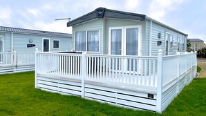A mobile home with a white deck and a covered porch. - 63 Bude Perran Paradise (Newquay)