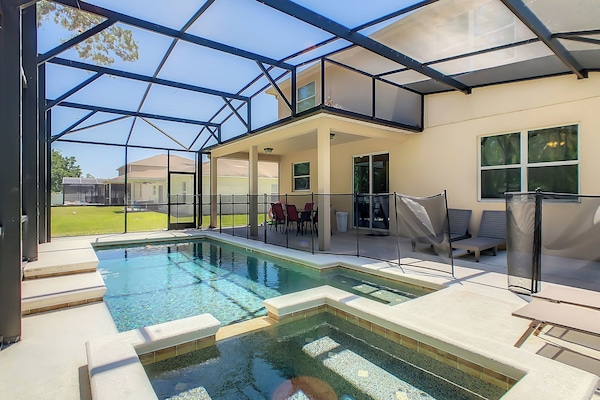 Screened backyard with heated pool and spa