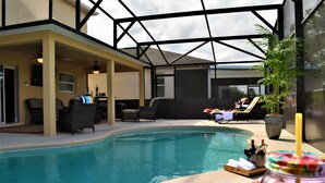 An indoor swimming pool with lounge chairs and a glass ceiling. - Exquisite Destination Villas... Crystal location (Kissimmee)
