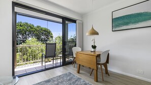 Enjoy a peaceful retreat with a balcony offering views, a dining table for meals, and a comfortable seating area.