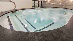 A hot tub with a stone wall and a metal railing. - Shadow Ridge 204 | Walk to Lifts | Kitchen | Fireplace | Pool & Hot Tub | Sauna | Fitness Room (Park City)
