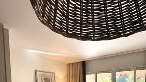 A modern living room with a sofa, a small table, and a dining area. - Apartment 4/5 persons Domaine et Golf international de Pont Royal (Mallemort)