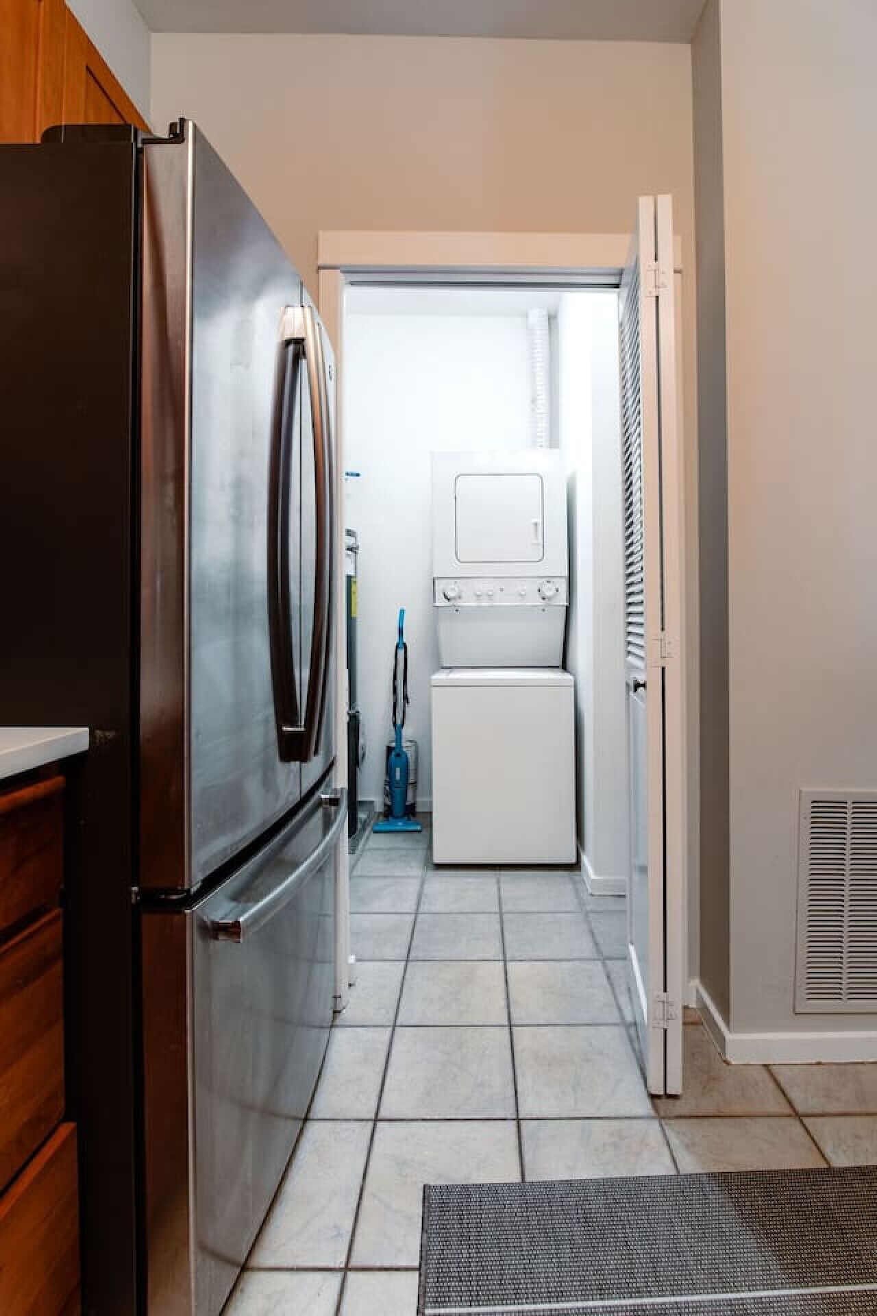 A compact kitchen with a refrigerator, oven, microwave, and dishwasher.