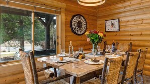 A wooden interior with a dining table set for six, surrounded by wicker chairs. - Abode at Black Bear #104, private hot tub, pool & gym, Deer Valley (Park City)