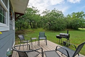 An outdoor deck with metal chairs and a grill. - 4 Tiny Town + Monthly + Utilities + Comfy Stay (Hico)