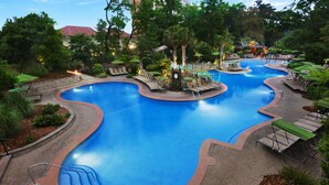 A large, curved swimming pool with multiple lounge areas and steps leading into the water. - OCEANFRONT Marriott's OceanWatch Resort, 2BR2BA Garden view Villa NO clean fee (Myrtle Beach)