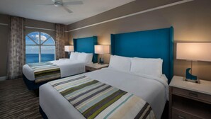 A hotel room with two beds, a large window with a view, a ceiling fan, and nightstands with lamps. - OCEANFRONT Marriott's OceanWatch Resort, 2BR2BA Garden view Villa NO clean fee (Myrtle Beach)