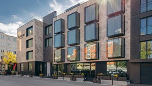 A modern hotel with a glass facade, large windows, and a clean, contemporary design. - Hotel MANAMI (Pristina)