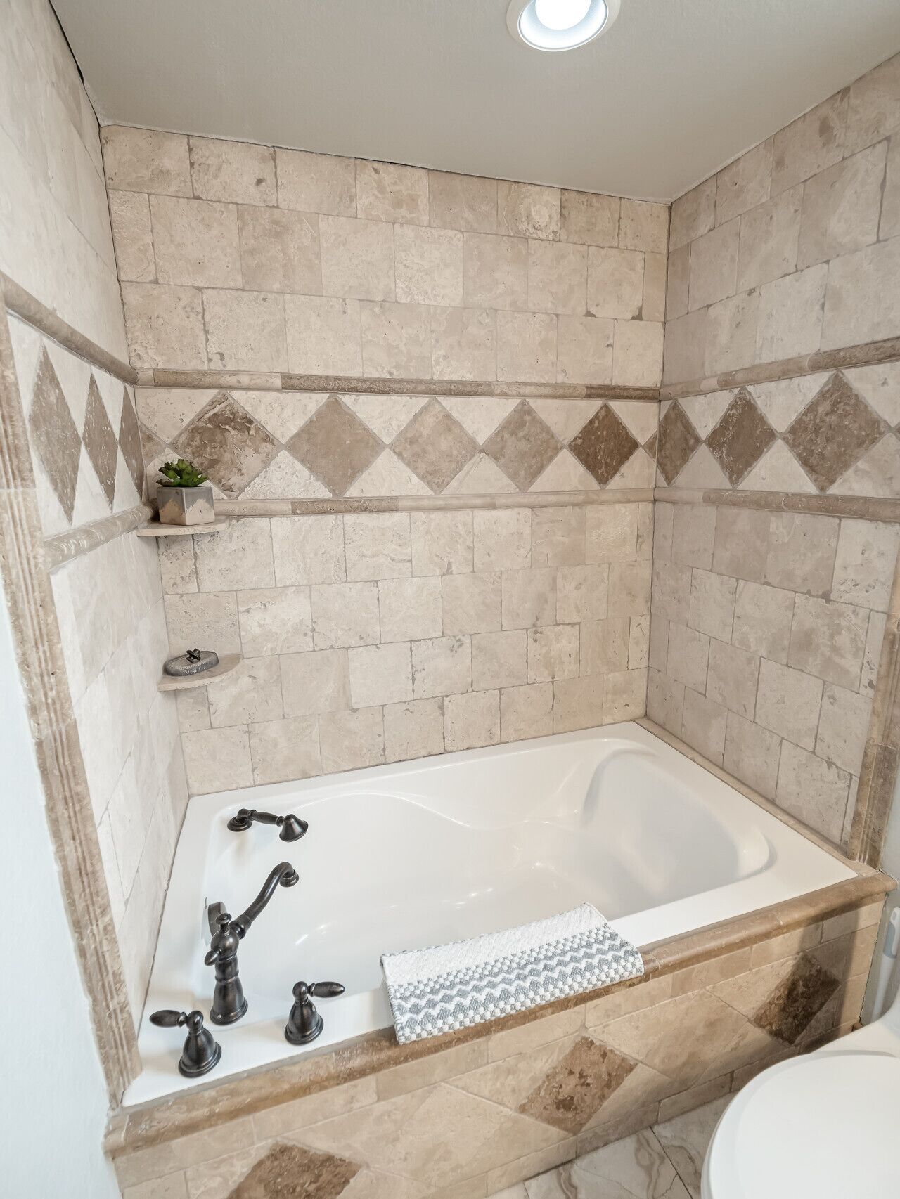 A bathroom with a bathtub, a toilet, and a shower area.