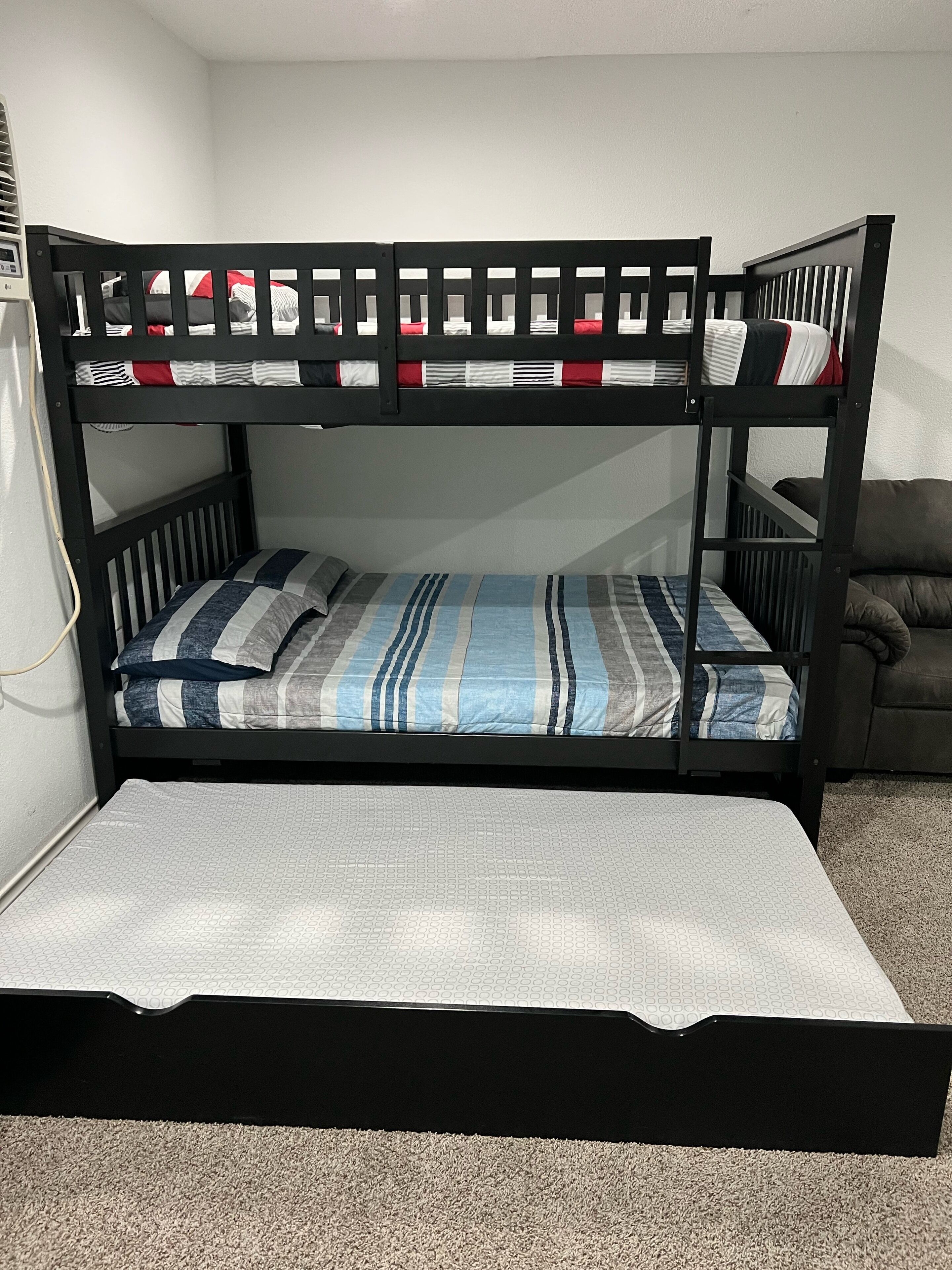 A bunk bed with a lower bunk and a mattress on the floor.