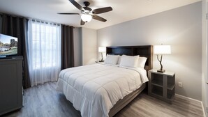 A hotel room with a bed, ceiling fan, TV, and nightstands. - ACL Super Home  . 4 bedroom with Hot spa in the backyard in an awesome neigbohoo (Round Rock)