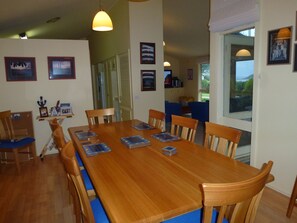 Enjoy meals with family and friends in this cozy dining area, surrounded by a view of the outdoors.
