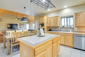Enjoy cooking in this well-equipped kitchen with a central island, sink, and dishwasher.