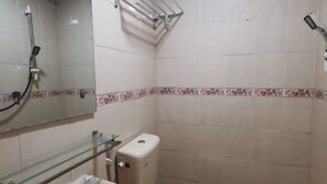 A small bathroom with a toilet, sink, and shower. - Hotel O My Seven Days Inn (Masai)