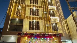 A building with a reception area at the ground level, featuring a staircase leading up to it. - Hotel Golden Bliss (Bhopal)