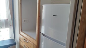 A kitchen with a white refrigerator, wooden cabinets, and a window with sheer curtains. - 2-room South/West with Wifi in Tignes, 5 sleeps, mountain view (Tignes)