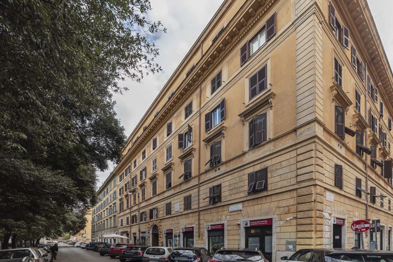 A multi-story building with a classical architectural style, featuring a symmetrical facade with evenly spaced windows and a central entrance.