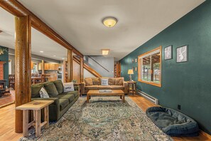 A cozy living room with a sofa, coffee table, and a patterned rug.