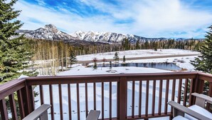 A deck with a view of a snowy landscape, a lake, and mountains in the distance. - Mid Century Modern Condo - Deck with Great Views - Heated Pool (Durango)