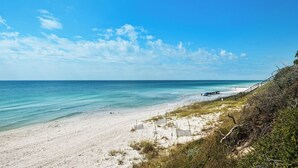 A beach with a clear sky, sandy shore, and a staircase leading down to the water. - Classic Beach Home - Heated Private Pool, Sleeps 11 +Free Attraction Tickets! (Santa Rosa Beach)